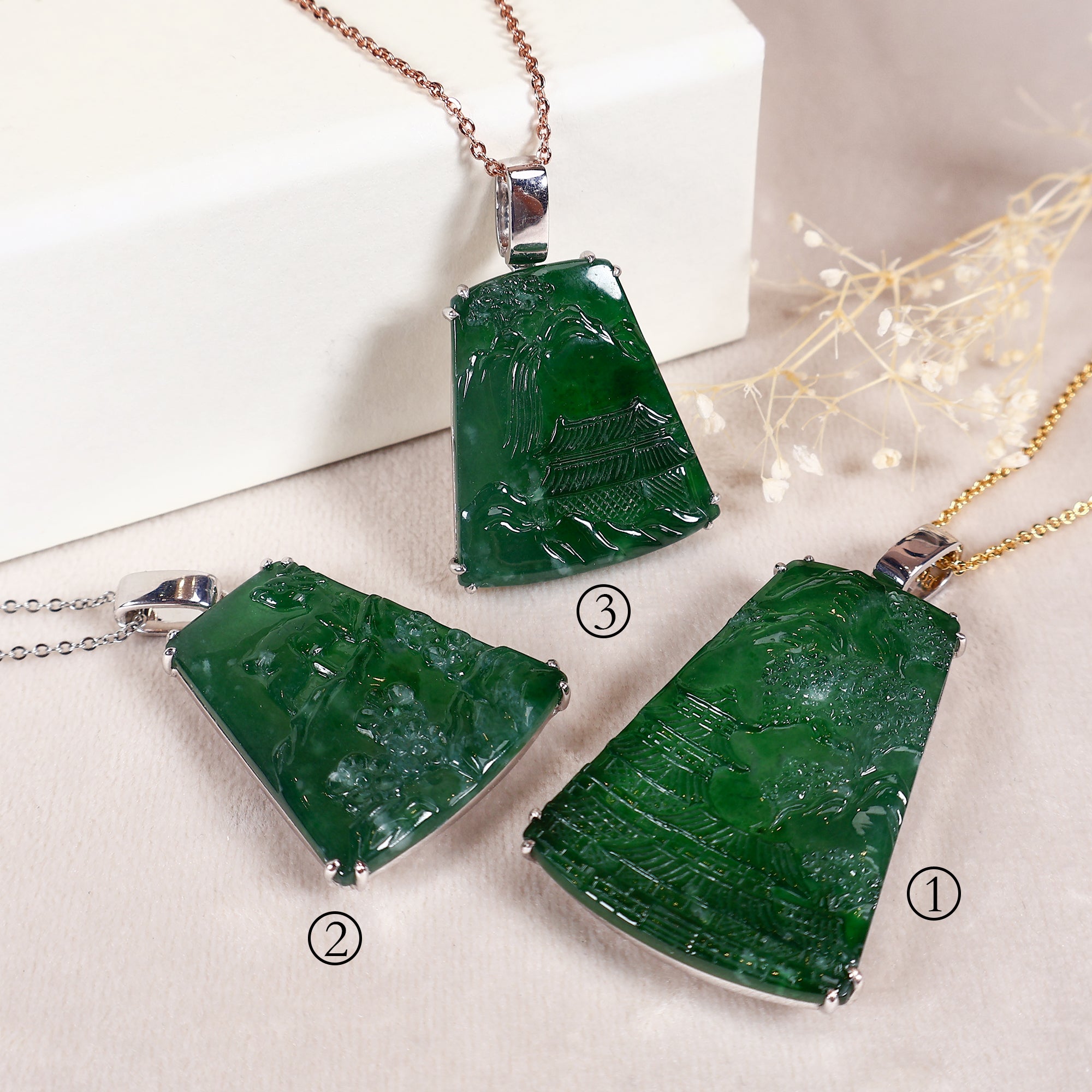 Three jade pendants of different sizes carved with landscapes