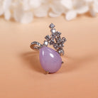 A uniquely shaped purple jade and a uniquely designed ring with multiple diamonds