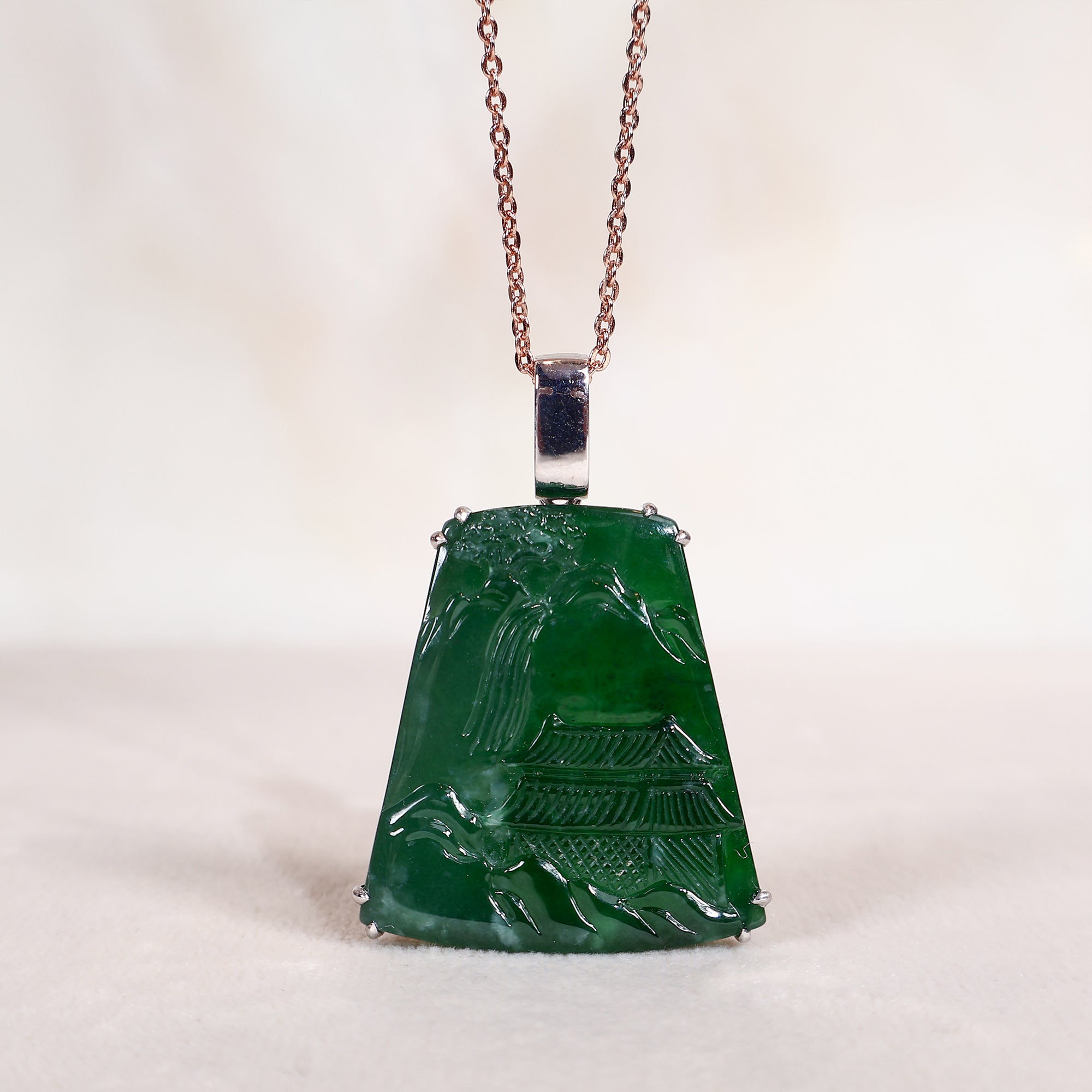 Jade pendant with landscape carvings